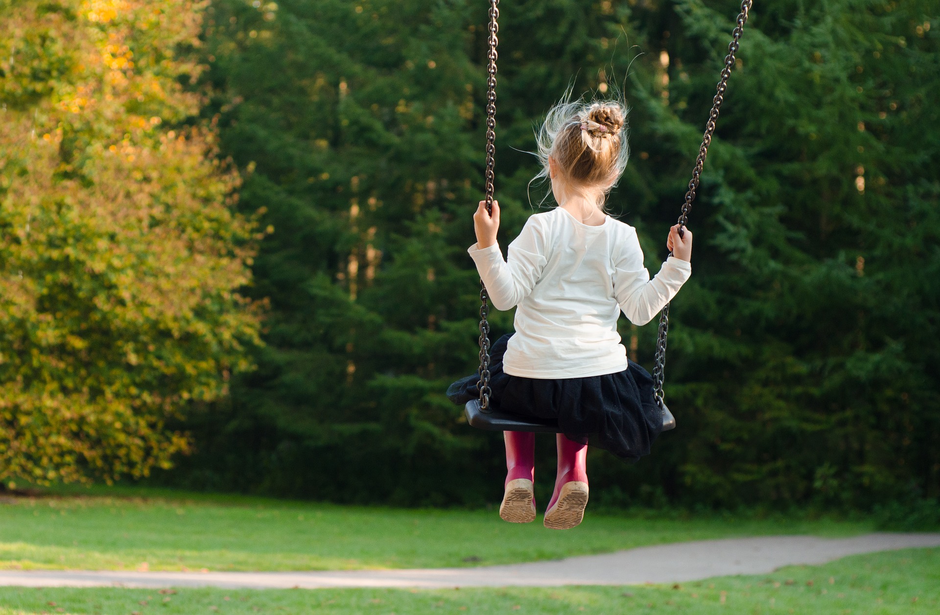 Young girl swinging on the swing at the playground, shapiro educational & behavioral consultants